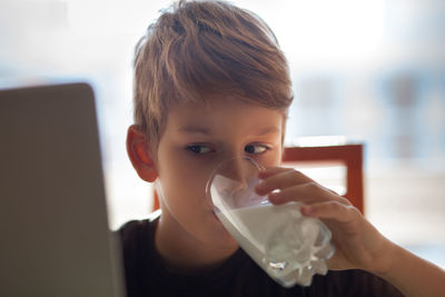 Boy drinking milk at home