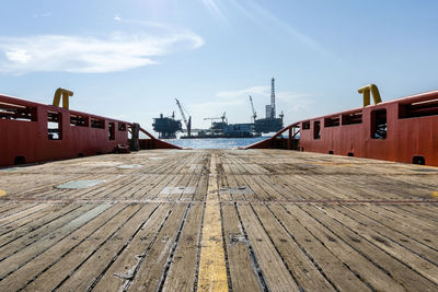 View of pier amidst houses against sky