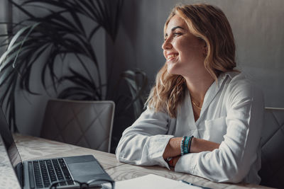 Young woman using laptop at home