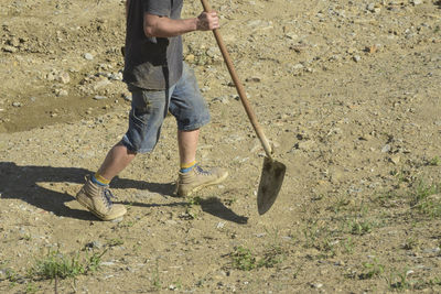 Low section of man working on field