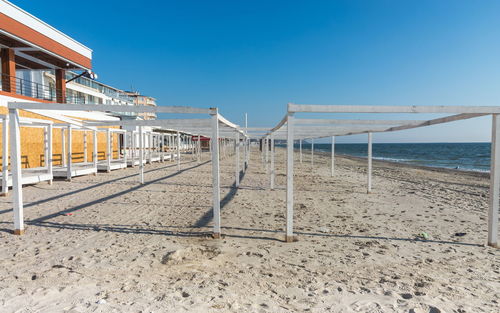 Scenic view of beach against clear blue sky