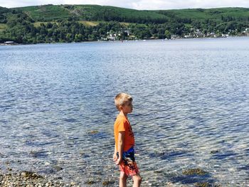 Full length of boy standing on beach