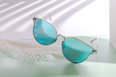 Close-up of sunglasses on glass table