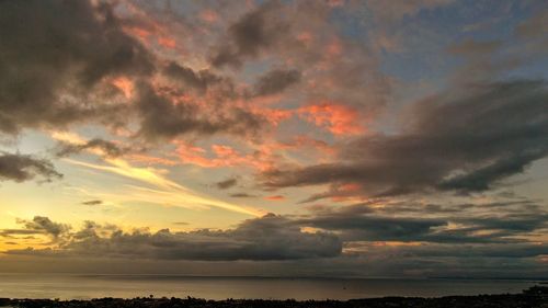 Scenic view of dramatic sky over sea during sunset
