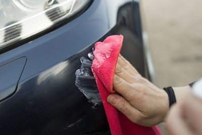 Cropped hand of person holding car