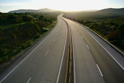 Empty road along countryside landscape