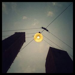 Low angle view of power lines against sky