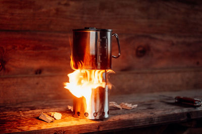 Close-up of burning candle on table