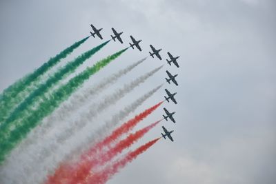 Low angle view of airplane flying against sky