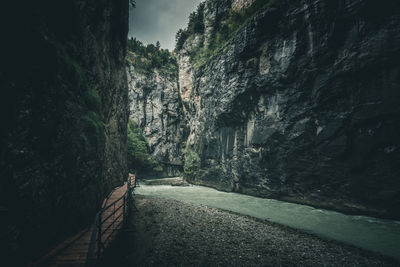 Footpath amidst rocks against mountain