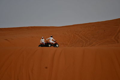 Man riding motorcycle in desert