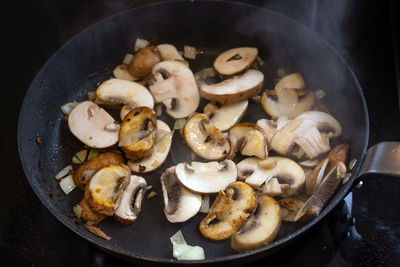 High angle view of mushrooms in cooking pan