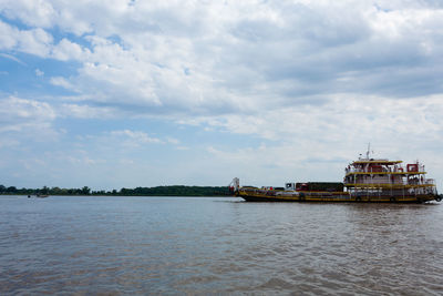 Boat sailing in sea against sky