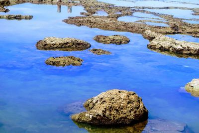 Rocks in sea against sky