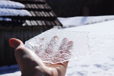 Midsection of person holding ice cream during winter