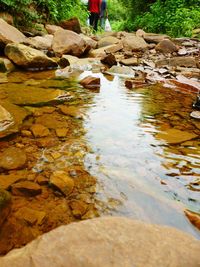 View of stream flowing through rocks
