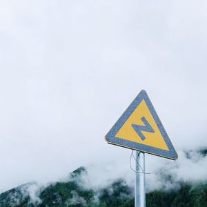 Road sign against sky