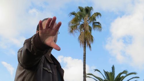 Low angle view of palm tree against sky