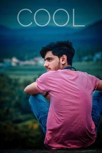 Rear view of man looking away while standing on land