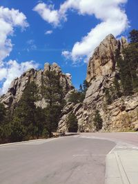 Road amidst rocks and mountains against sky