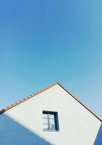 Low angle view of house against clear blue sky