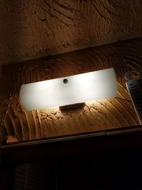 Low angle view of illuminated electric lamp