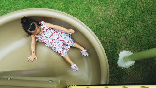 High angle view of asian girl sliding down