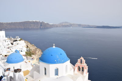 Panoramic view of sea and buildings against sky