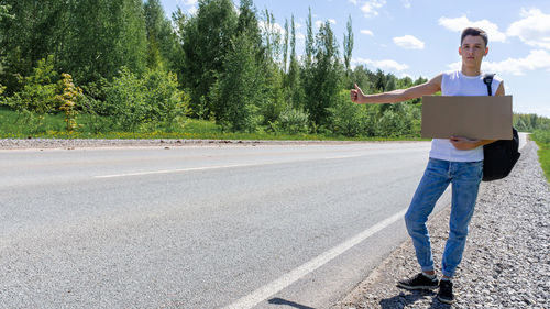 Full length of woman standing on road