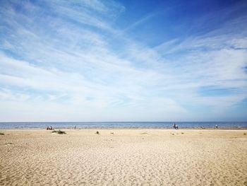 Scenic view of beach against blue sky