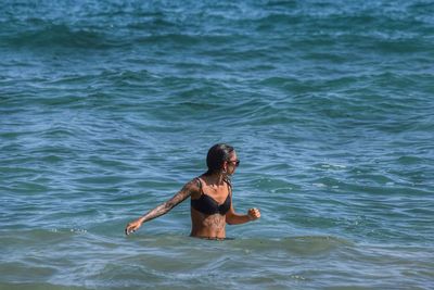 Bikini woman swimming in sea