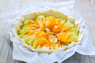 Close-up of yellow zucchini blossoms in plate