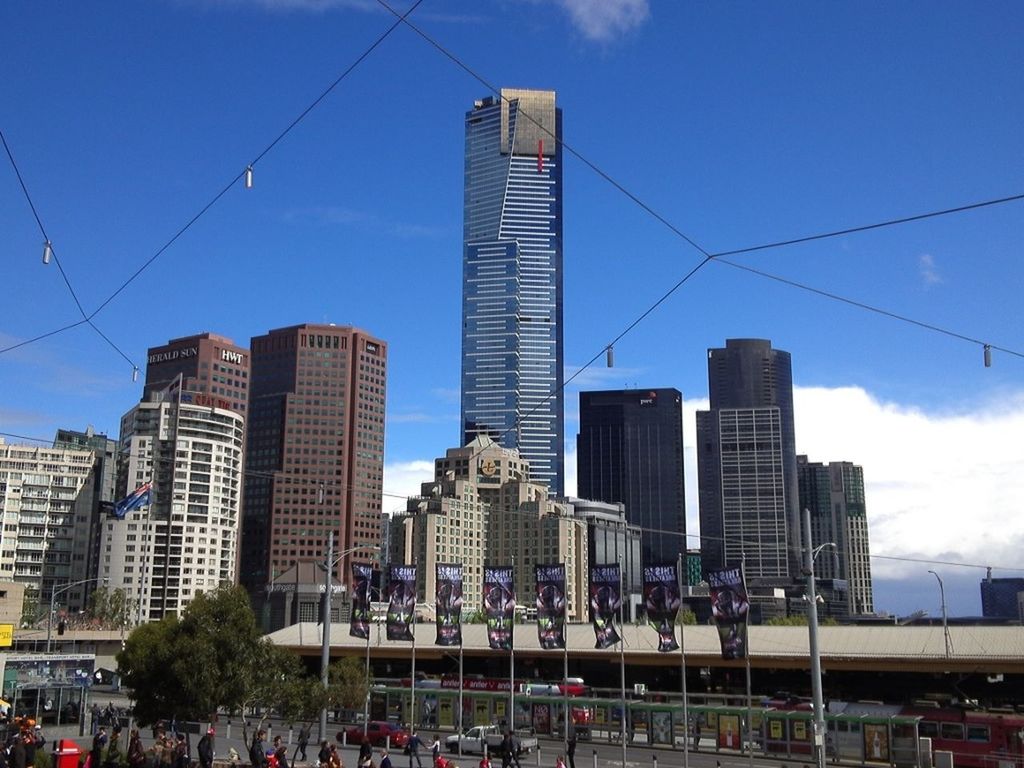 building exterior, architecture, built structure, city, skyscraper, blue, tall - high, city life, sky, office building, modern, tower, low angle view, power line, building, cityscape, cable, urban skyline, day, outdoors