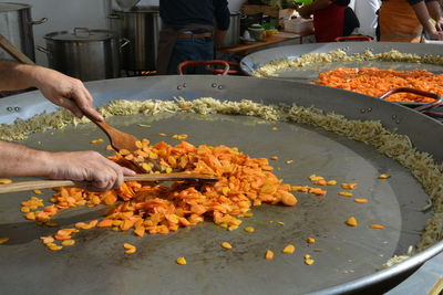 Cropped image of hand holding food at market stall