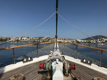 Boat sailing on sea against clear sky