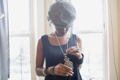 A young woman wearing a tweed hat