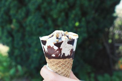 Close-up of hand holding ice cream cone