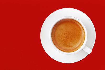Directly above shot of coffee on yellow background