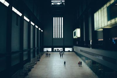 People walking in illuminated building