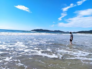 Full length of man on beach against sky