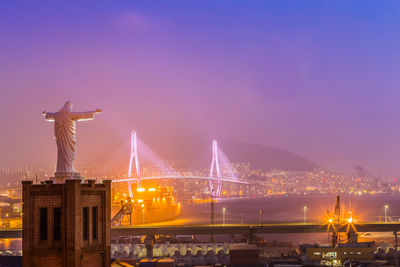 View of illuminated city against sky at night