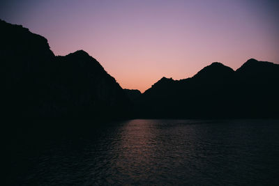 Scenic view of silhouette mountains against sky at sunset