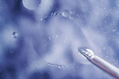 Close-up of water drops on glass