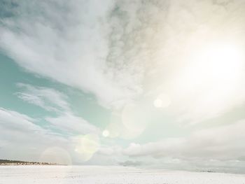 Scenic view of snow covered fieldagainst sky