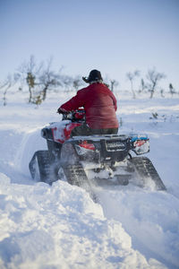 Man riding quad at winter