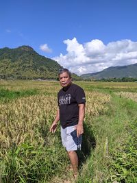 Full length of man standing on field against sky