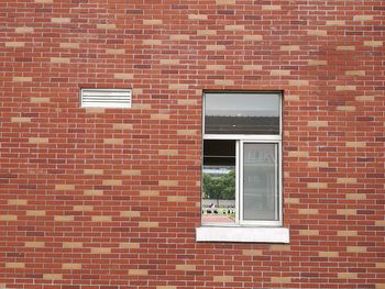 Teacher and students seen through building window