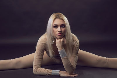 Portrait of young woman sitting outdoors