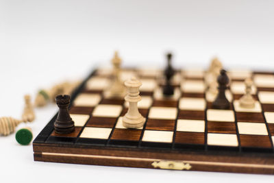 Close-up of chess pieces against white background