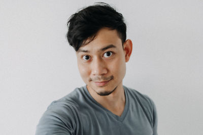 Portrait of young man against white background